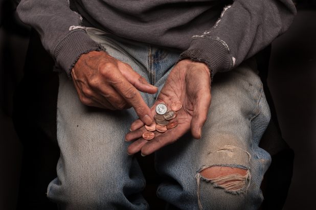 Homeless man counting change.
